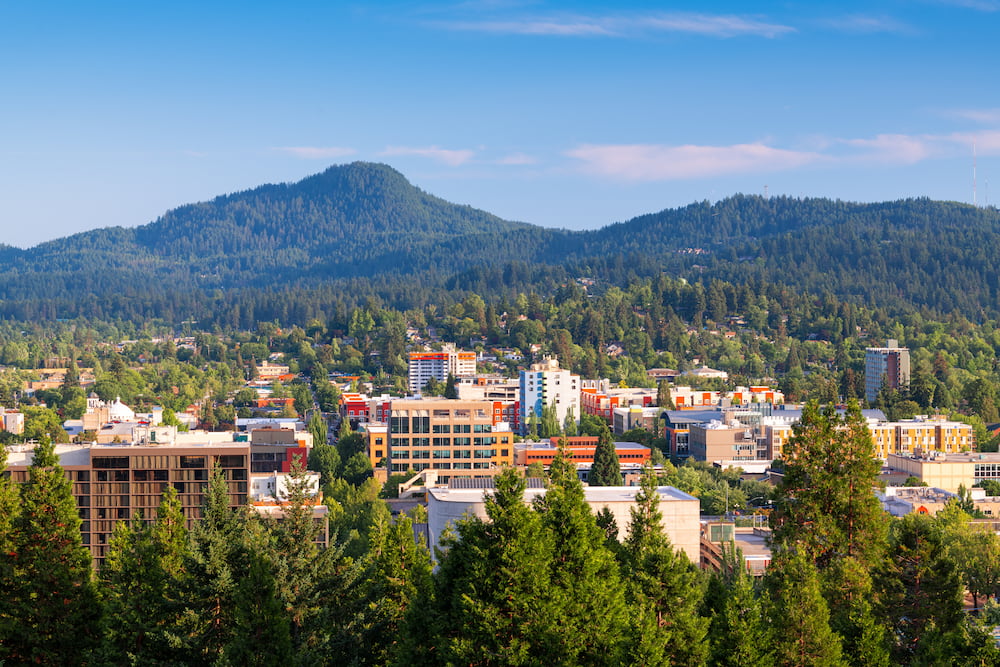 Eugene, Oregon, USA downtown cityscape and mountains in the afternoon.